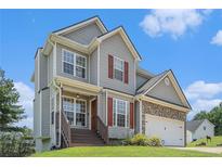 Charming two-story home featuring light gray siding, brown accents, and a well-manicured lawn at 201 Providence Dr, Dallas, GA 30157
