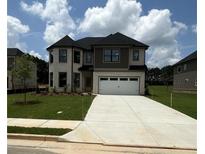Beautiful new construction home with a well manicured lawn and two car garage at 1522 Reserve Glen Dr, Lawrenceville, GA 30043