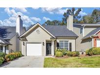 Charming home featuring a well-maintained lawn and appealing front facade with an attached garage and black door at 1338 Gates Se Dr, Atlanta, GA 30316