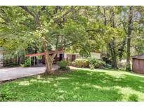Charming single-story home with a covered carport and mature trees shading the front yard at 2991 Monterey Drive Dr, Decatur, GA 30032