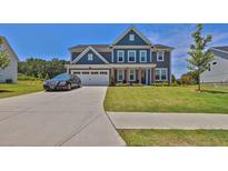 Charming two-story home with a well-manicured lawn and a paved driveway at 611 Sugar Prairie Bnd, Lawrenceville, GA 30045