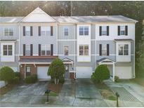 Charming townhome featuring a well-manicured lawn and a convenient one-car garage at 1768 Oakbrook Nw Ln # 9, Kennesaw, GA 30152
