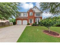 Charming two-story home with a well-manicured lawn, mature trees, and a two-car garage at 27 Spur Ct, Hiram, GA 30141