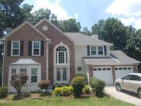 Charming two-story home with brick accents, manicured landscaping, and an attached two-car garage at 4125 Fastnet Lane, Duluth, GA 30096