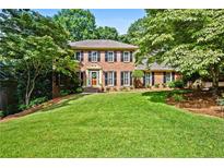 Beautiful two-story brick home with a well-manicured lawn and mature trees at 5130 Stoneywood Se Cir, Mableton, GA 30126