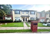 Two-story townhome with neutral siding, black shutters, manicured lawn, and brick mailbox at 134 Odyssey Turn, Conyers, GA 30012