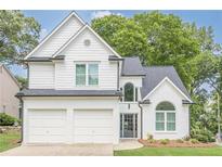 Charming two-story home with white brick and siding, attached two-car garage, and well-maintained landscaping at 86 Whitlock Sw Sq, Marietta, GA 30064