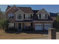 Charming two-story brick home with a two-car garage and well-maintained landscaping at 1090 Chapel Hill Drive Southeast, Lawrenceville, GA 30045