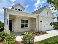 Charming single-Gathering home with a covered porch, manicured landscaping, and a two-car garage at 7220 Winderlea Ln, Cumming, GA 30040