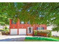 Traditional brick home with attached two-car garage and manicured front lawn at 5900 Fairington Farms Lane Ln, Stonecrest, GA 30038