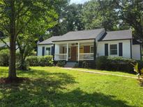 Charming single story home with a welcoming front porch and well-manicured lawn at 1617 Columbia Drive, Decatur, GA 30030