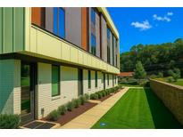 Modern townhome showcasing manicured lawn, walkway and architectural detail at 2424 Memorial Drive Se Dr # 3, Atlanta, GA 30317