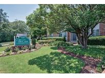 Well-maintained condominium complex entrance with mature landscaping and signage for The Cove Condominium Homes at 4266 Roswell Ne Rd # H4, Atlanta, GA 30342