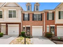 Charming brick townhome with attached garage and well-manicured landscaping at 786 Brookside Parc Ln, Avondale Estates, GA 30002