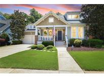 Charming home featuring a covered porch, neat landscaping, and an attached two-car garage at 126 Woodbury Ln, Canton, GA 30114