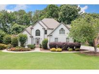 Charming two-story home with well-manicured lawn and mature landscaping at 1345 Benbrooke Nw Ln, Acworth, GA 30101
