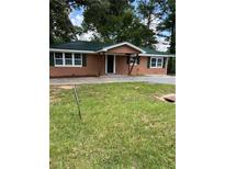 Charming single story home with a green metal roof and inviting front porch at 10591 Flat Shoals Rd Rd, Covington, GA 30016