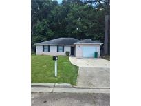 Charming single-story home featuring a well-maintained lawn and a convenient attached garage at 2322 Wilkins Ct, Decatur, GA 30035