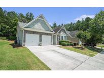 Charming single-Gathering home with a two-car garage and well-maintained landscaping at 1856 Temple Park Dr, Loganville, GA 30052