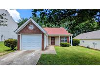 Charming single-story home featuring a well-maintained lawn and attached one car garage at 6572 Chestnut Oaks Rdg, Lithonia, GA 30038