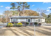 Charming single-story home featuring a covered front porch, neutral siding, and well-maintained landscaping at 1035 Stonewall Se Dr, Atlanta, GA 30315