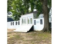 Charming home featuring a well-kept yard, prominent tree, and a welcoming entryway at 546 Hamilton E Holmes Drive Northwest, Atlanta, GA 30318