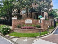 Brick sign at Brookhaven Township features flowers and landscaping in a well-maintained community at 2584 Oglethorpe Ne Cir, Brookhaven, GA 30319