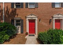 Charming townhome with a striking red front door and well-maintained landscaping at 2886 Webb Bridge Rd, Alpharetta, GA 30009