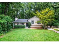Charming single-Gathering home with a well-manicured lawn and mature trees at 1131 Hershey Dr, Marietta, GA 30062