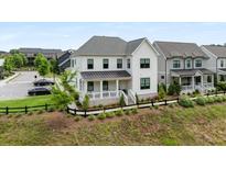 Charming two-story home with a welcoming front porch and well-manicured lawn, perfect for curb appeal at 6320 Halcyon Garden Dr, Alpharetta, GA 30005