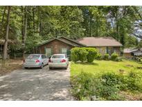 Inviting single-story home with a charming facade and well-maintained front yard and ample parking space at 652 Post Oak Rd, Jonesboro, GA 30238