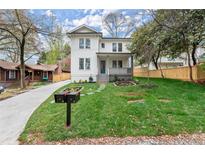 Charming two-story home with a well-manicured lawn, beautiful landscaping, and inviting front porch at 779-A Lynwood Se St, Atlanta, GA 30312