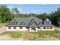 A charming one story home with a large roof and well-manicured lawn at 1730 Etchison Spur, Loganville, GA 30052