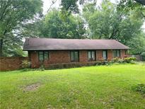 Ranch-style home featuring a brick facade, large yard and mature trees at 2641 Old Norcross Rd, Tucker, GA 30084