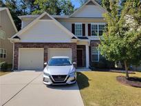 Charming two-story home featuring a two-car garage, brick accents, and well-maintained landscaping at 3020 Ben Blvd, Austell, GA 30106