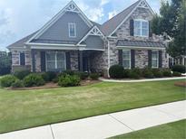 Beautiful stone and shake home with manicured lawn and charming curb appeal at 848 Rolling Nw Hl, Kennesaw, GA 30152