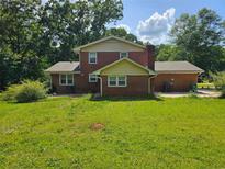 Brick two-story home with a chimney and a spacious backyard at 1106 Sharonton Way, Stone Mountain, GA 30083