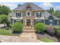 Stunning stone and stucco home with manicured landscaping, a welcoming entrance, and a beautiful stone walkway at 3090 Creek Tree Lane, Cumming, GA 30041