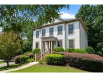 Charming two-story home with well-manicured landscaping and covered front porch at 1215 Renaissance Se Ct, Mableton, GA 30126