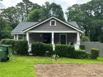 Charming single-story home with a covered porch and mature landscaping at 184 Nathan Sw Rd, Atlanta, GA 30331