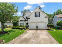 Charming two-story home with a well-manicured lawn and a two-car garage, perfect for Gathering living at 217 Springs Xing, Canton, GA 30114