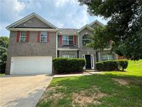 Two-story brick home with a two-car garage and well-manicured lawn at 4958 Wewatta Sw St, Atlanta, GA 30331