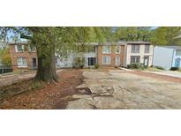 Charming townhomes showcasing varied facades and ample parking spaces in a well-maintained community at 5595 Marbut Rd, Lithonia, GA 30058