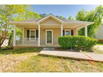 Charming single-story home features a covered porch and neutral exterior, complemented by a well-manicured lawn at 179 Glynn Addy Dr, Stockbridge, GA 30281
