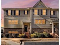 Charming townhome with gray siding, brick accents, black shutters, and manicured landscaping at 3898 High Dove Sw Way # 12, Smyrna, GA 30082