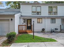 Charming two-story townhome featuring a welcoming front porch, siding, and well-manicured lawn at 102 Oak Pl, Villa Rica, GA 30180