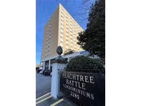 A full exterior of the Peachtree Battle Condominiums building with a sign out front at 2285 Peachtree Ne Rd # 1202, Brookhaven, GA 30309