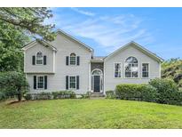 Charming home with white siding, dark shutters, and a well-manicured lawn at 304 Bennett Farms Ct, Acworth, GA 30102
