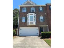 Charming two-story brick home with an attached two car garage and well maintained landscaping at 4210 Chatham Ridge Drive Dr, Buford, GA 30518