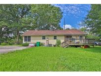 Spacious backyard with a wood deck and a partial view of the back of the house at 4636 Chamblee Tucker Rd, Tucker, GA 30084